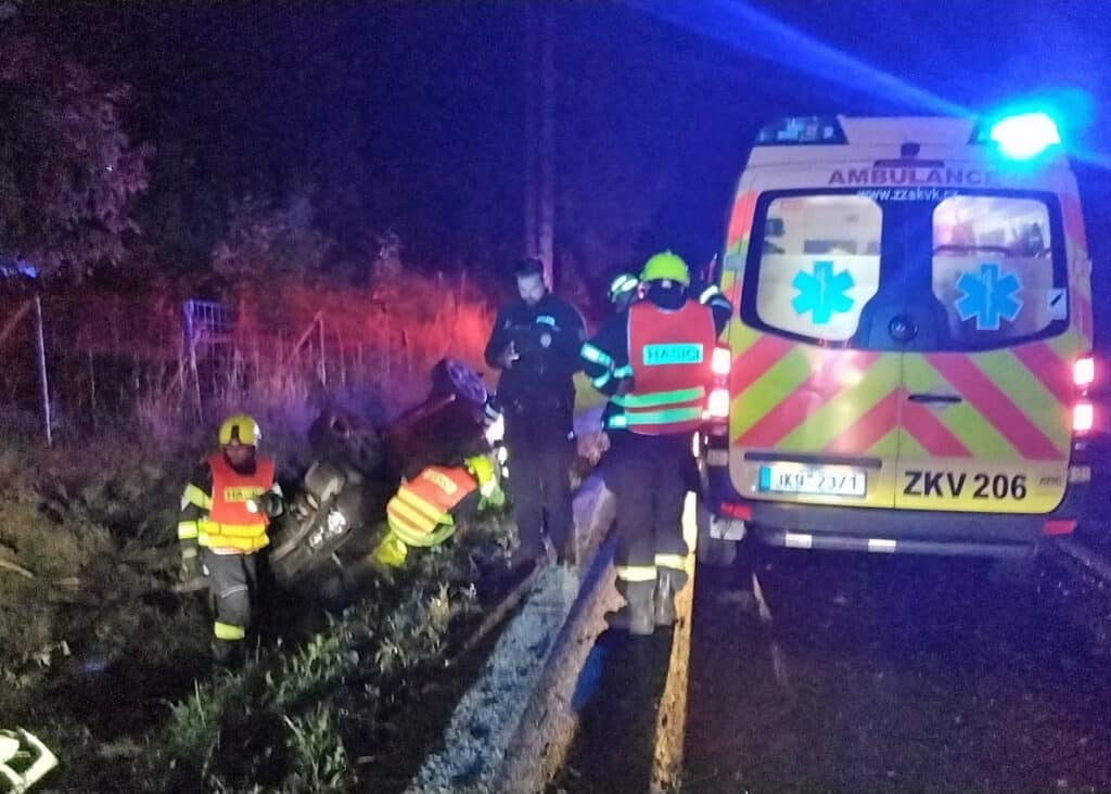 Další nehody se staly v noci na čtvrtek. Jedno auto skončilo na střeše v příkopu. Foto: HZS KVK